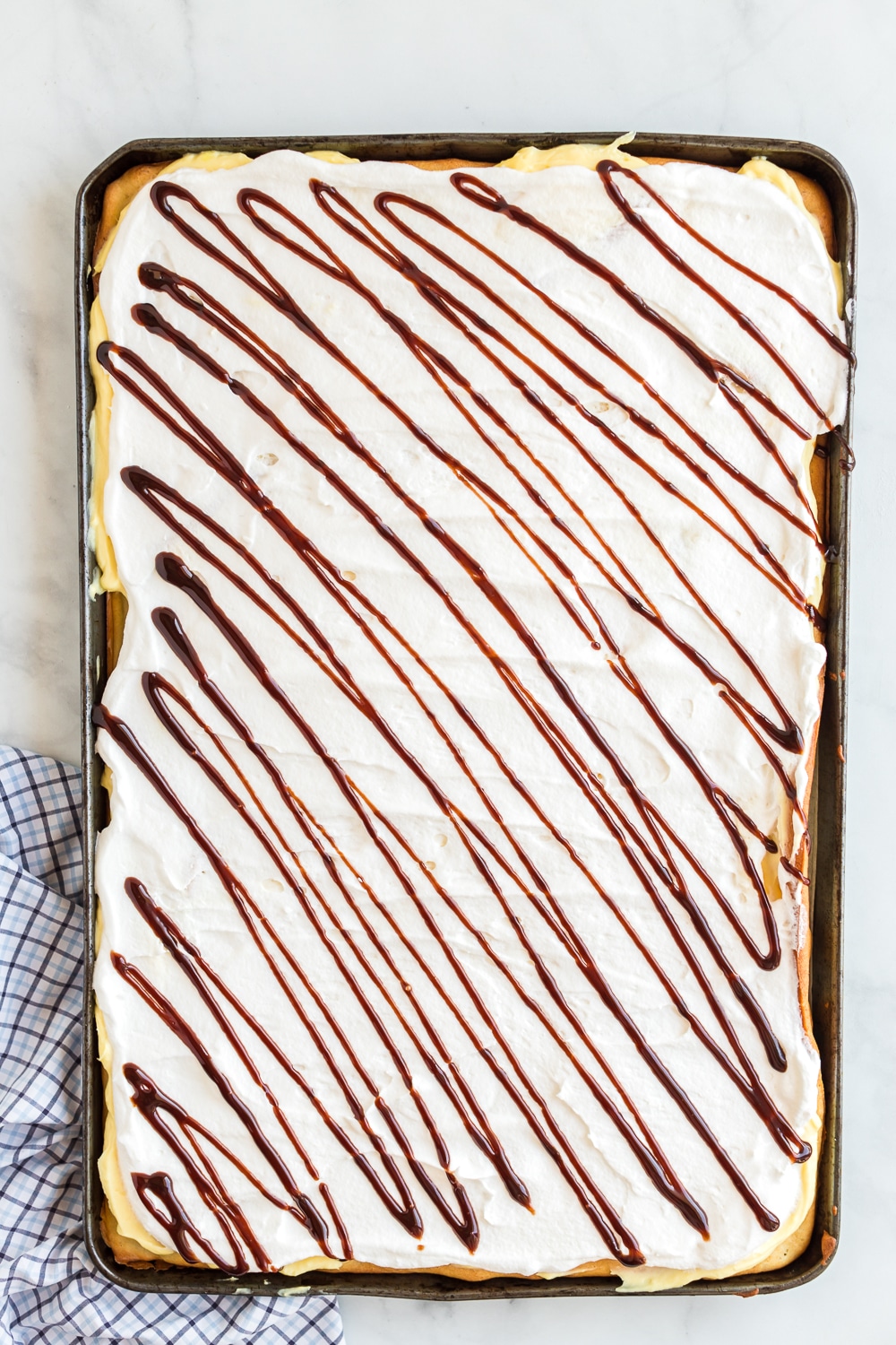 chocolate drizzle on eclair cake