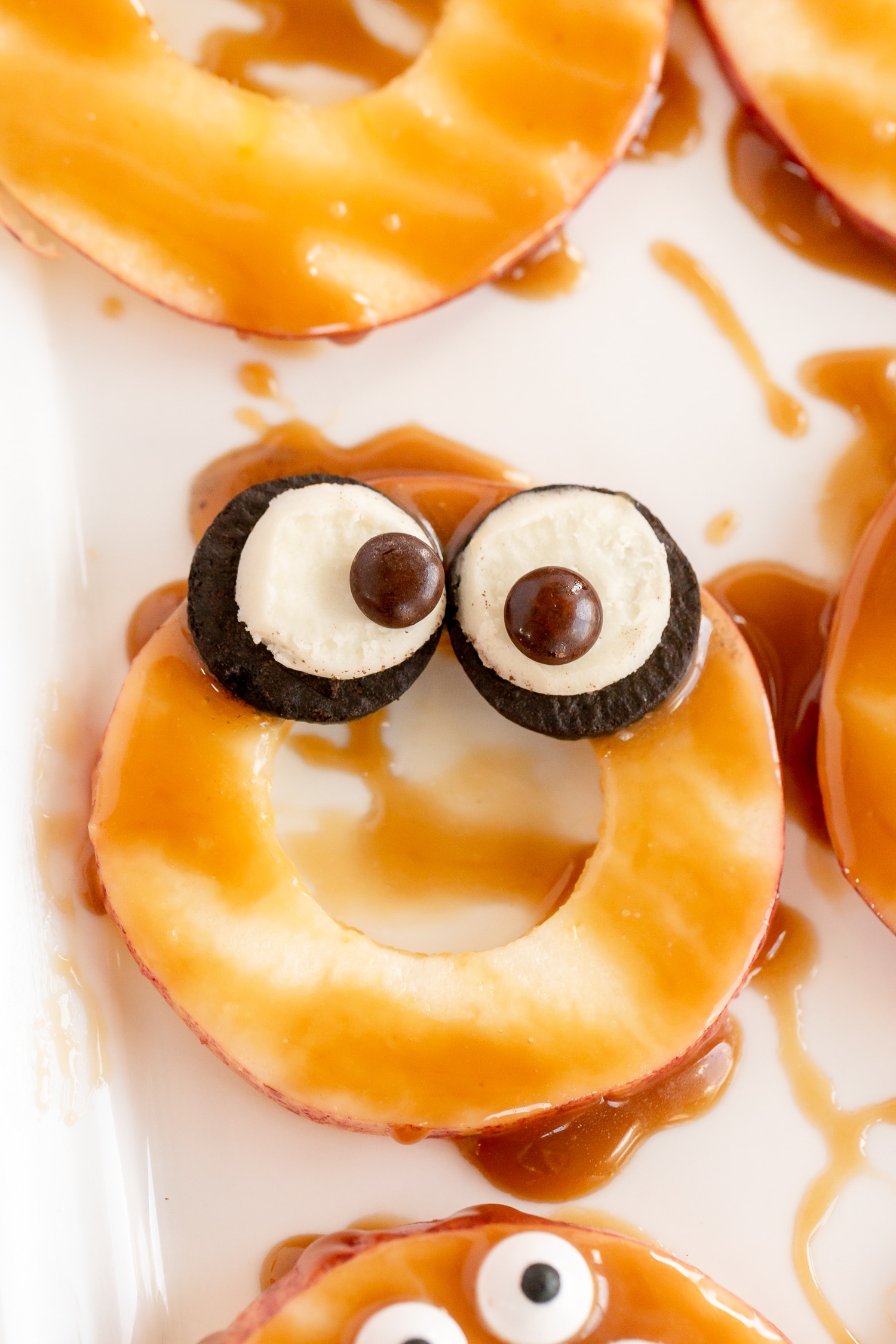 apple slice with caramel drizzle and oreo M& M eyes
