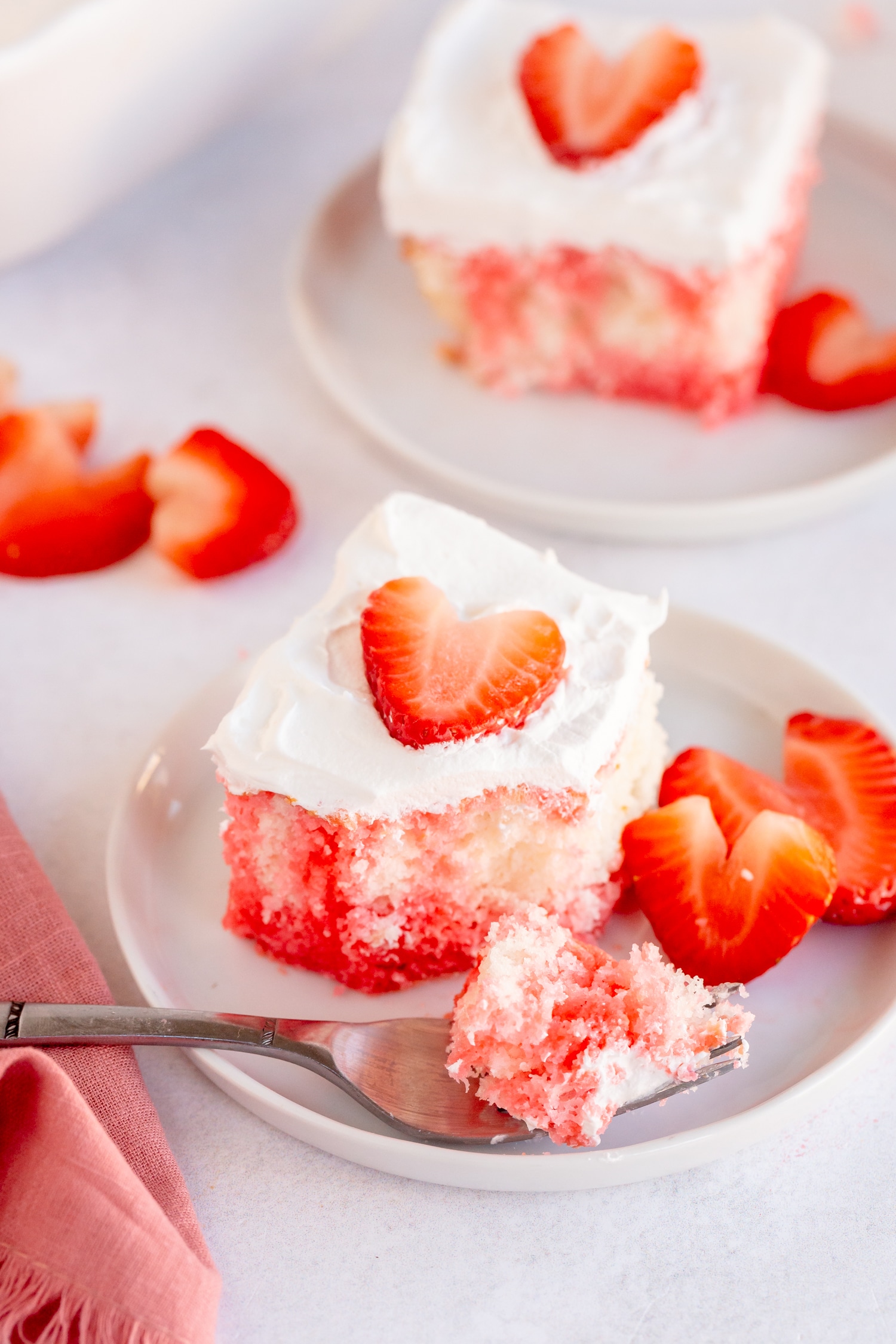 strawberry poke cake with strawberry slices