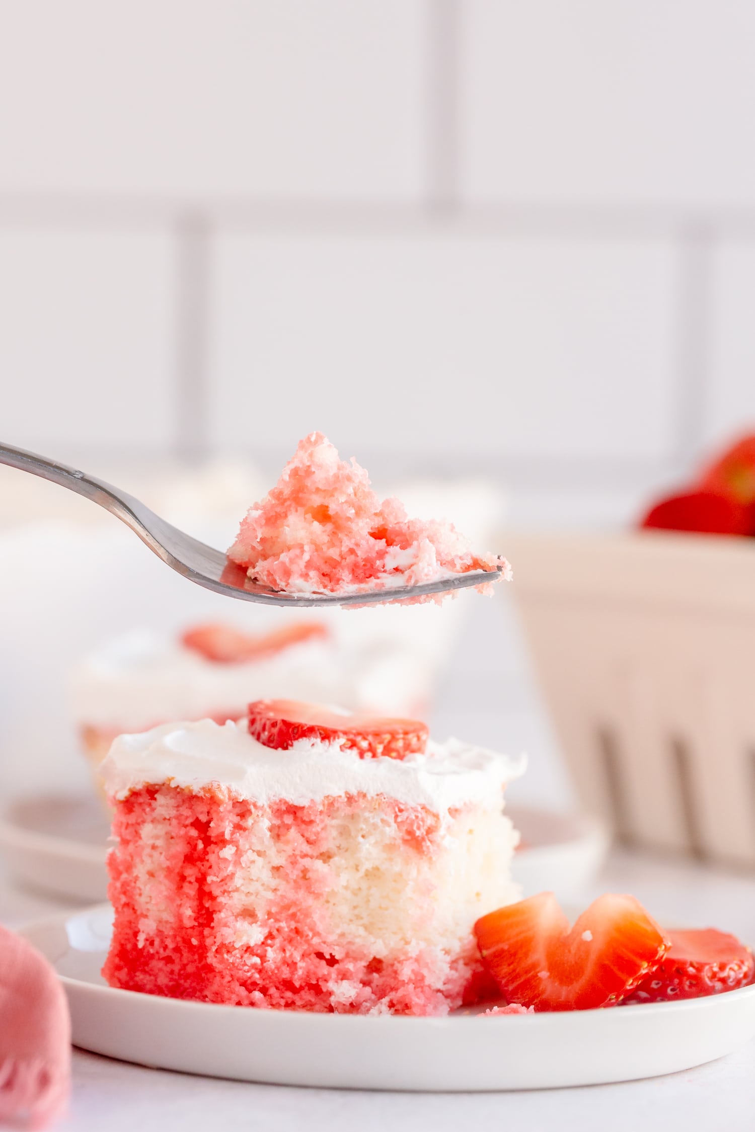 bite of strawberry poke cake
