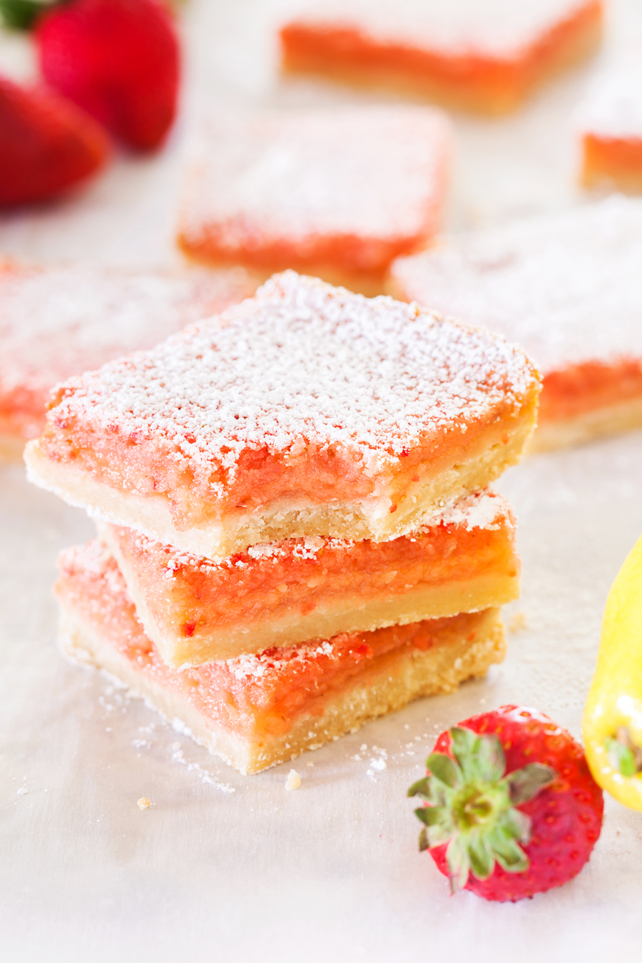 These Strawberry Lemonade Bars are a delicious bite of summer! Tangy lemonade and sweet strawberries make this a dessert you will be begging for seconds!
