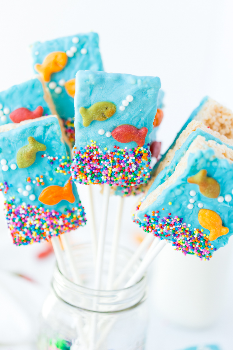 These Goldfish Crispy Cereal Treats are the perfect summer treat! Rice Krispie treats with a touch of blue candy melts, friendly goldfish and sprinkles makes this a fun treat for the kids! They are great for birthday parties, pool parties and more!