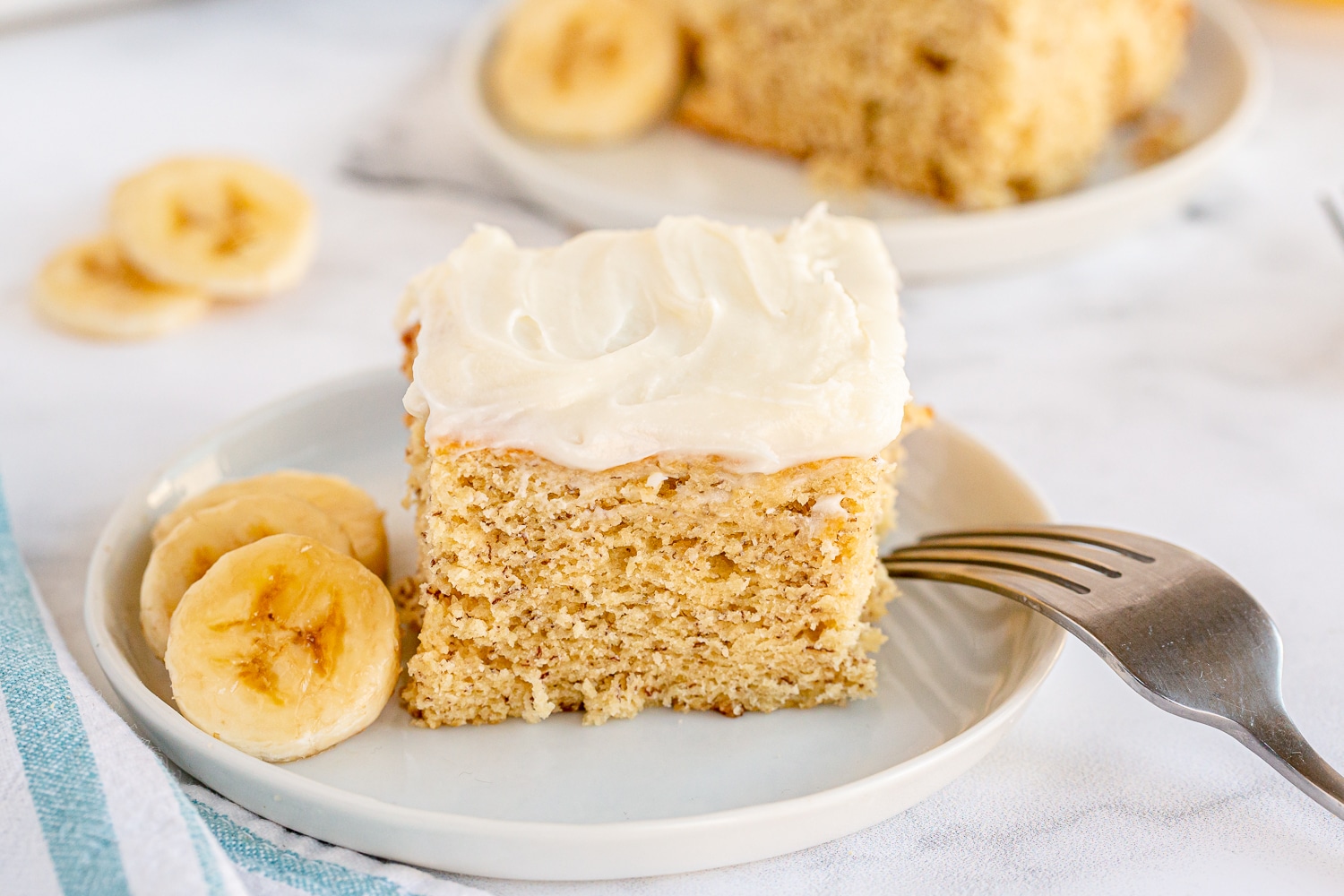 serving of banana cake on plate with banana slices