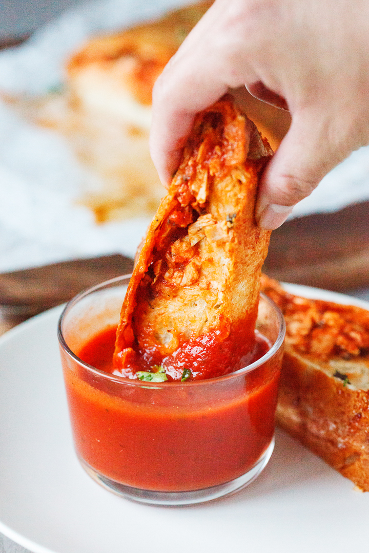 Chicken Stromboli dipped into sauce