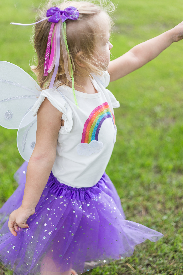 Rainbow Fairy Costume: a simple and sweet toddler costume idea that is perfect for Halloween or playtime.  A sparkly diy rainbow shirt and matching tutu are a perfect pair for any little rainbow fairy