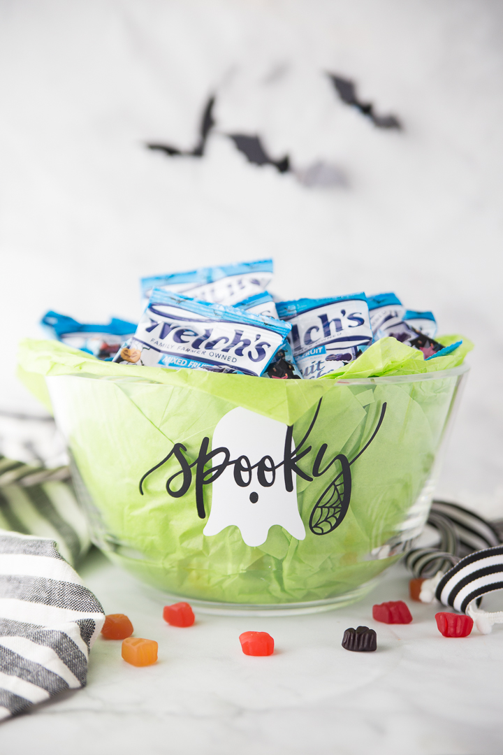 This DIY Halloween Trick-or-Treat Bowl is a fun and festive project for all your Halloween needs.  A clear serving bowl, some craft vinyl, festive treats, and a little spooky-ness is all you need to be serving up treats to all the trick-or-treaters. 