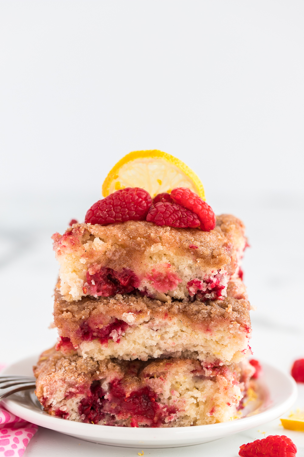 Lemon Raspberry Buckle Cake is a delicious and flavorful berry filled cake that is topped with a yummy crumb topping.  Great served for breakfast or with a scoop of vanilla ice cream for dessert.