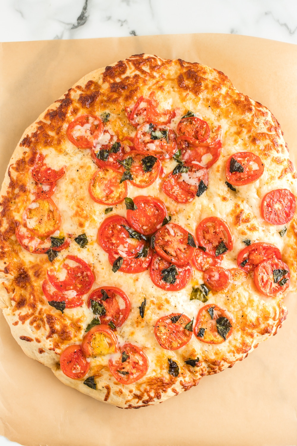 Margherita Pizza: a delicious homemade pizza full of flavor! Fresh tomatoes and basil are the key ingredients to this delicious and simple pizza recipe.
