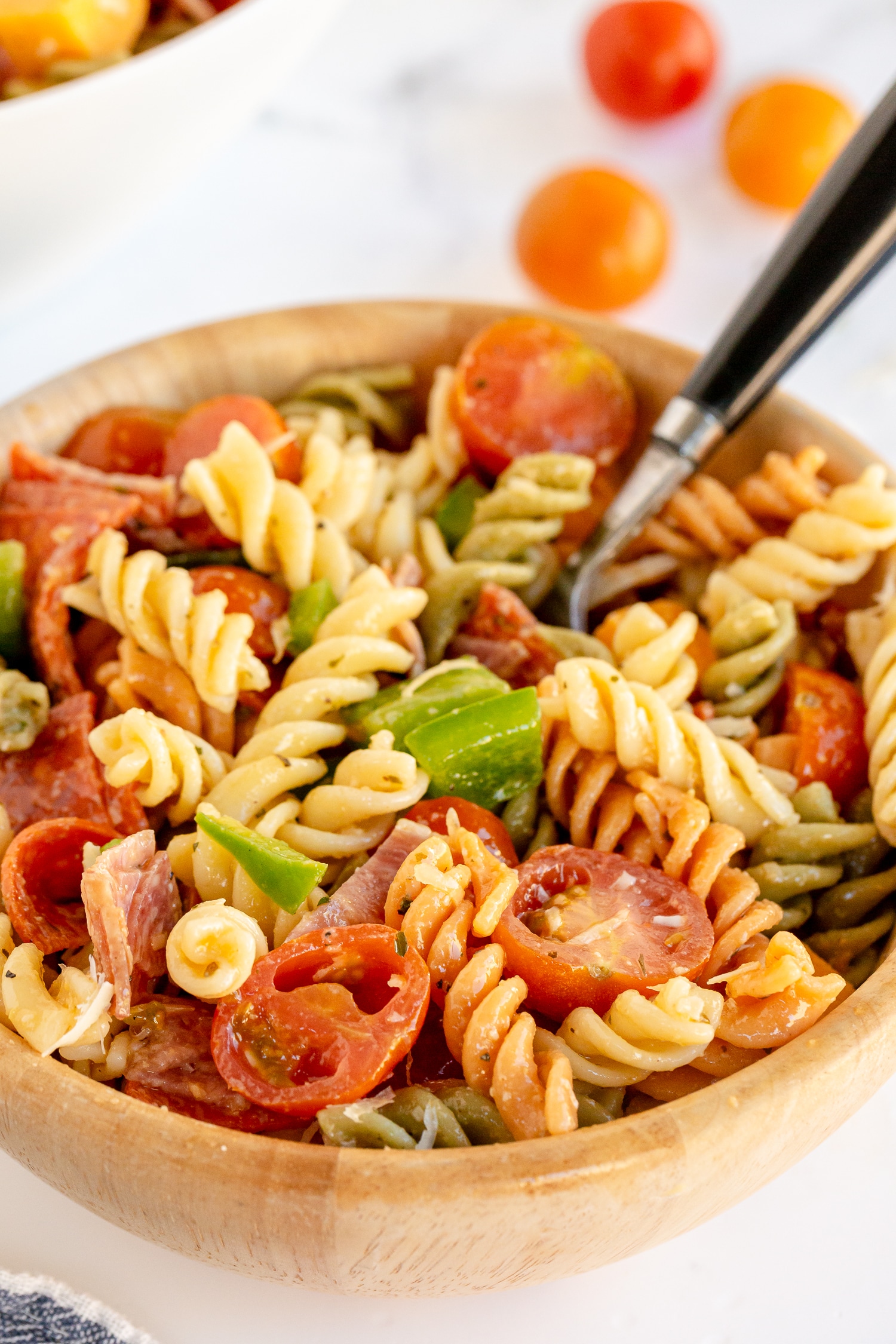 serving of pasta salad in wooden bowl