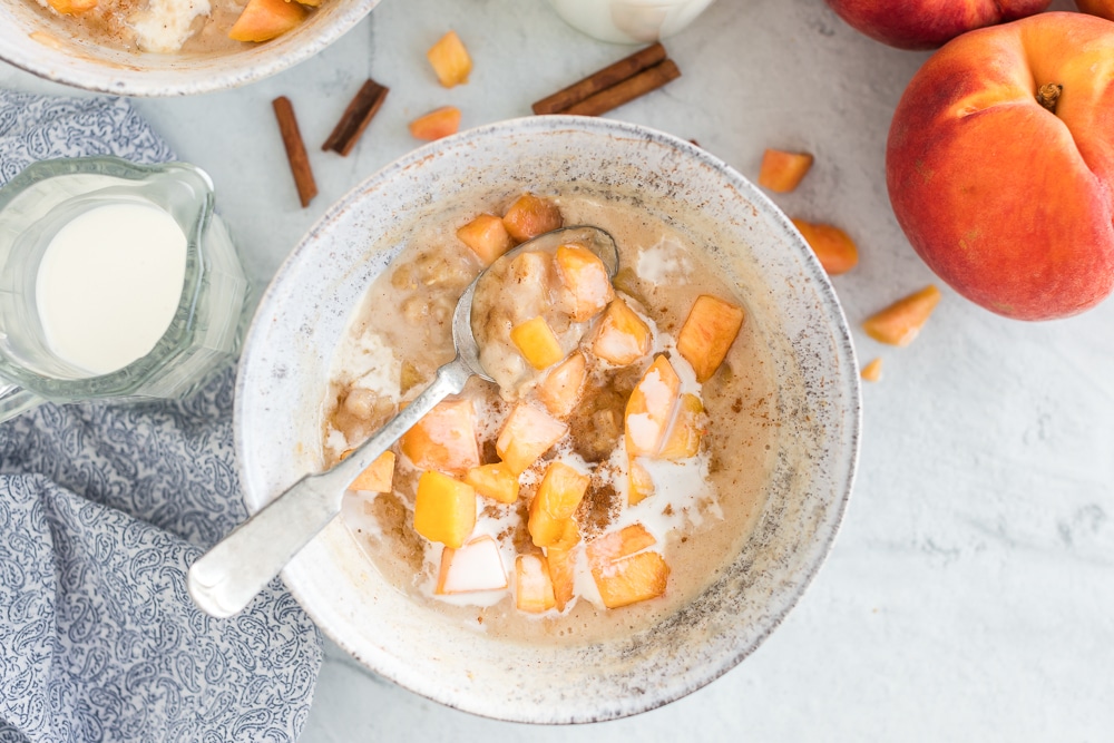 peaches in oatmeal topped with cream