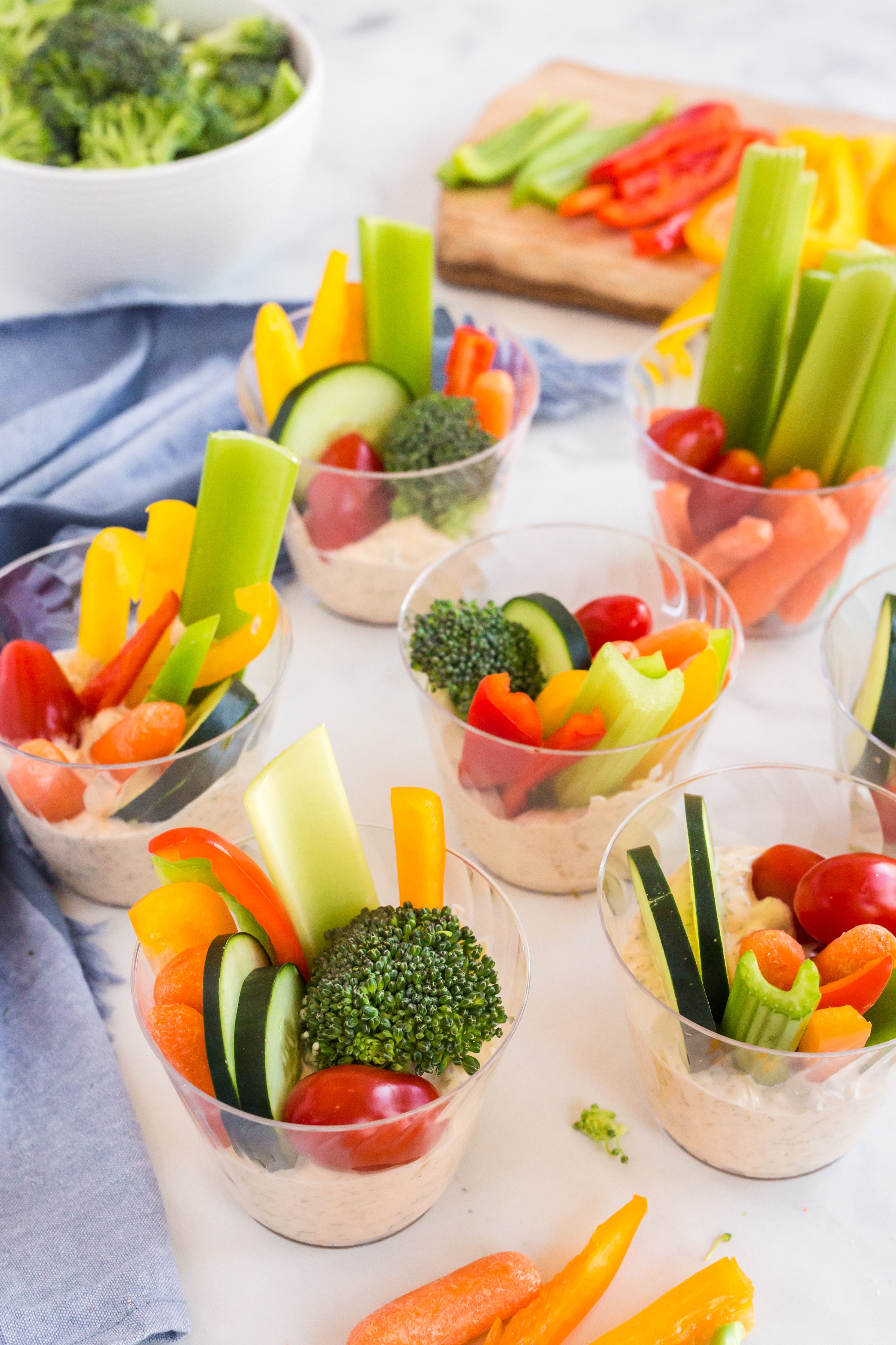 vegetable dip in single serving clear containers with veggies on top