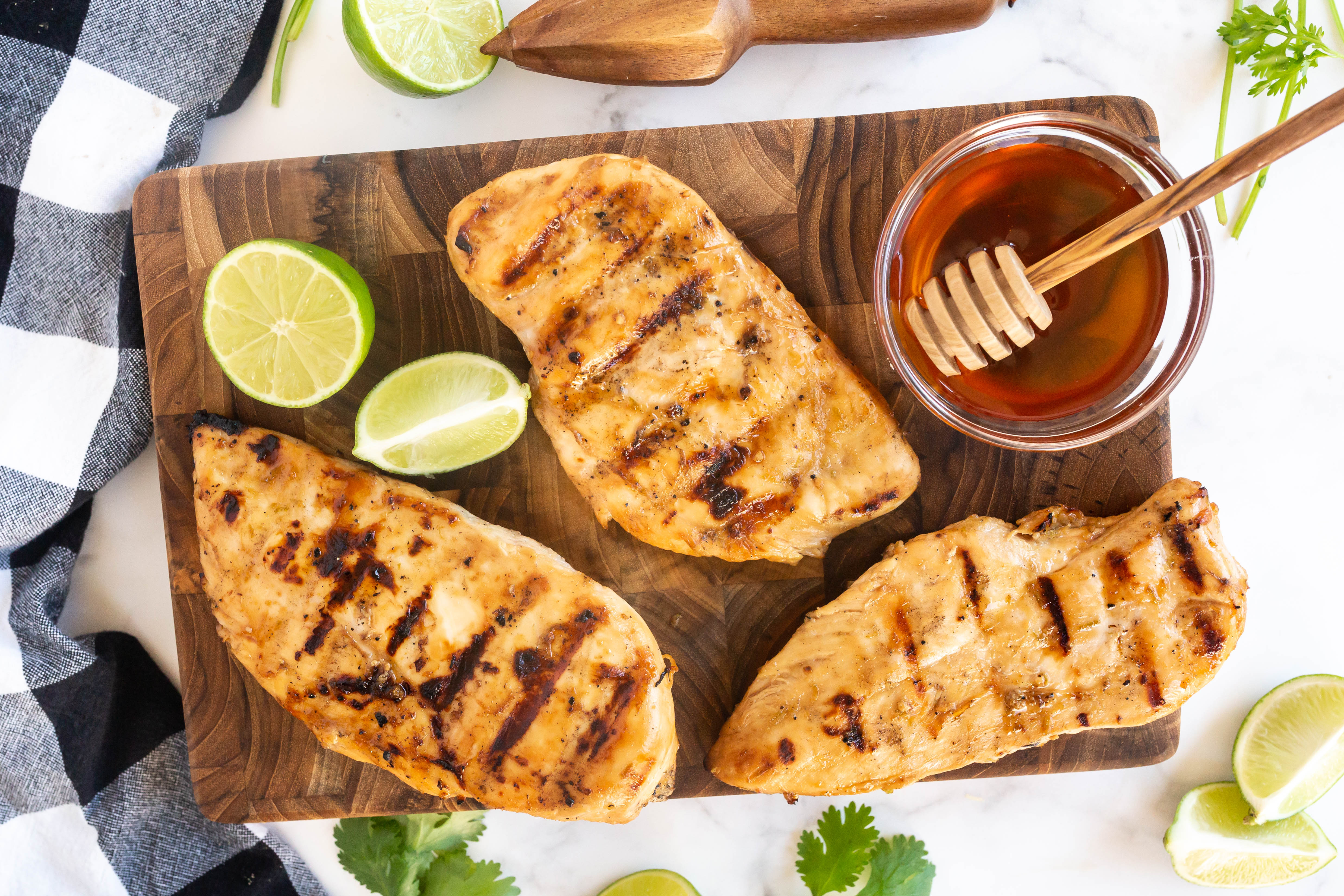 grilled chicken breasts on cutting board with honey