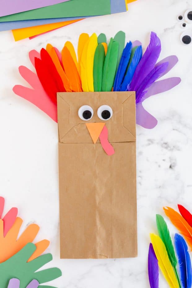 brown paper bag turkey craft with rainbow feathers