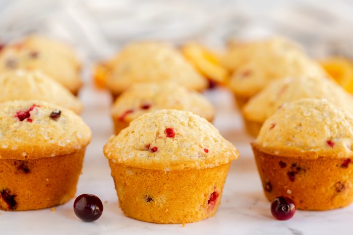 nine baked cranberry orange muffins place in a row