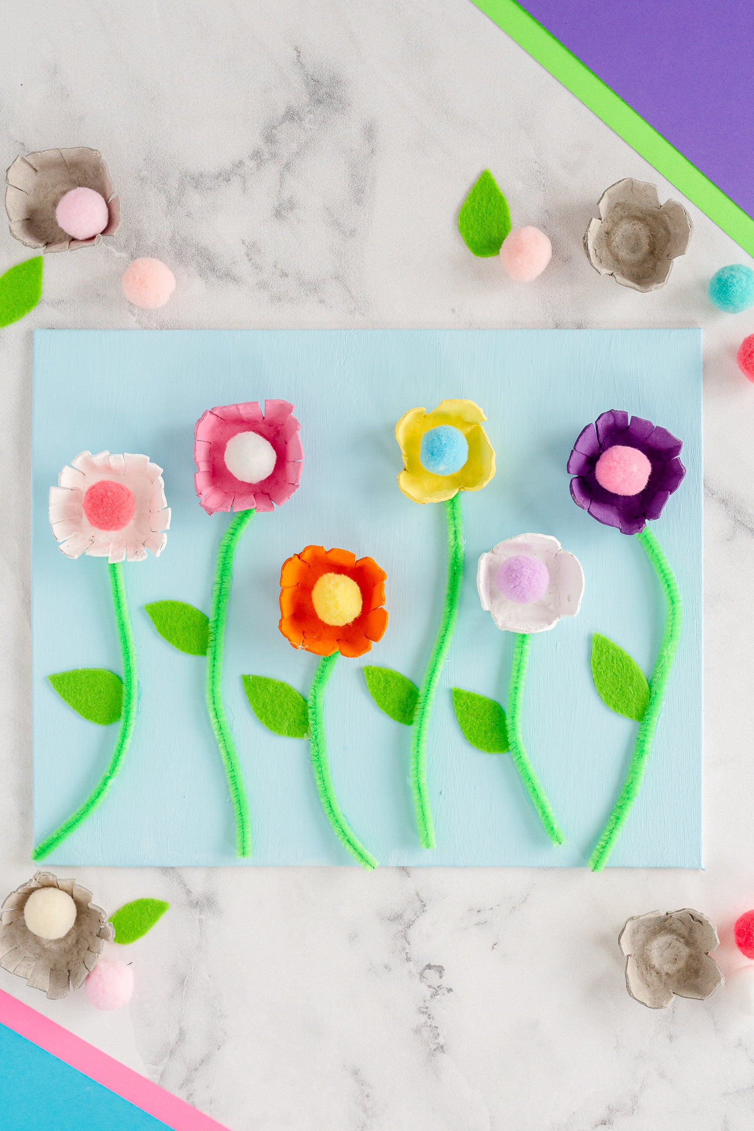 These Egg Carton Flowers are such a fun and pretty craft to celebrate the spring and summer season using recycled cardboard egg cartons and a few other craft supplies! 