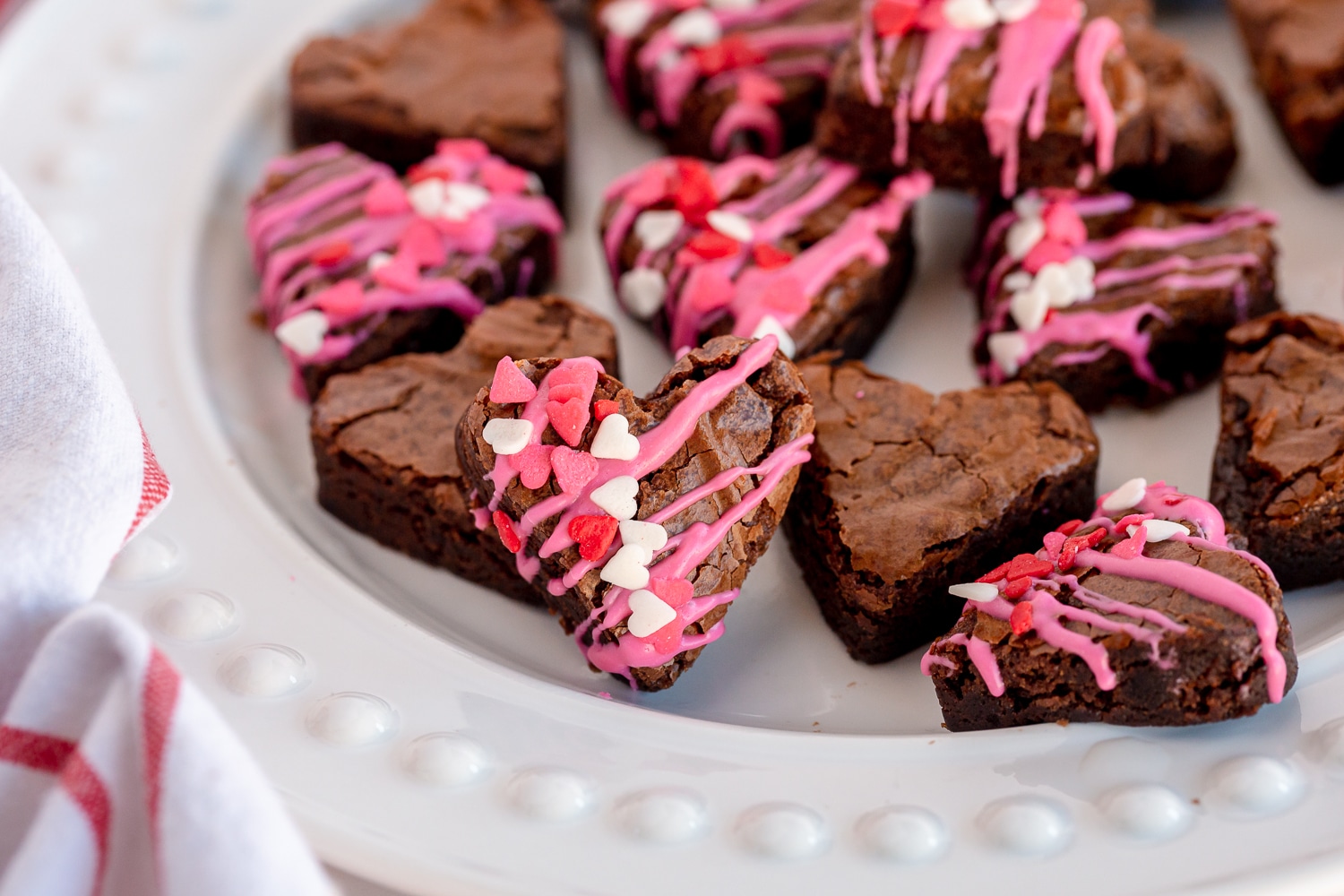 brownies cut into a heart shape with melted candy melts
