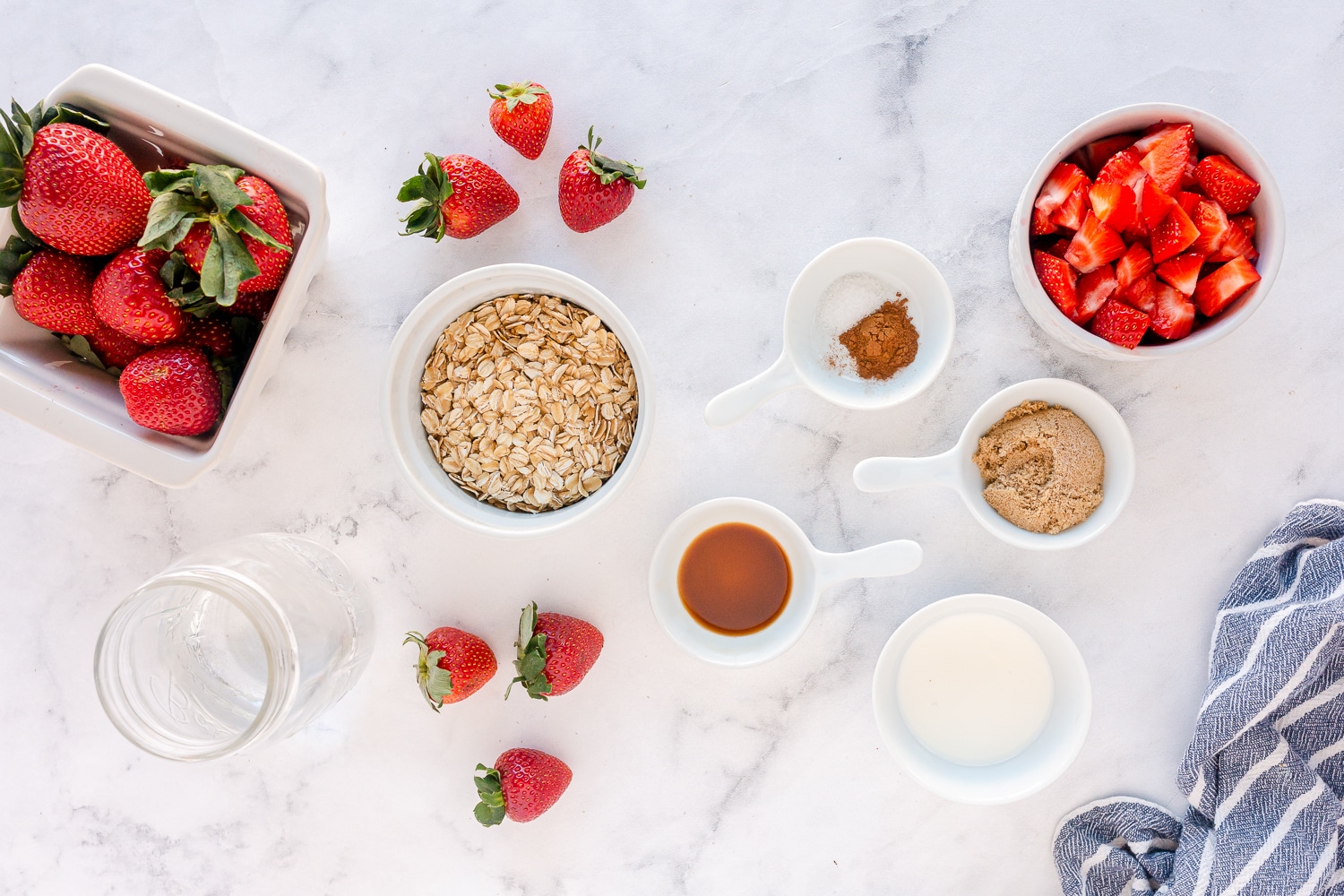 supplies needed for strawberry oatmeal in dishes on counter