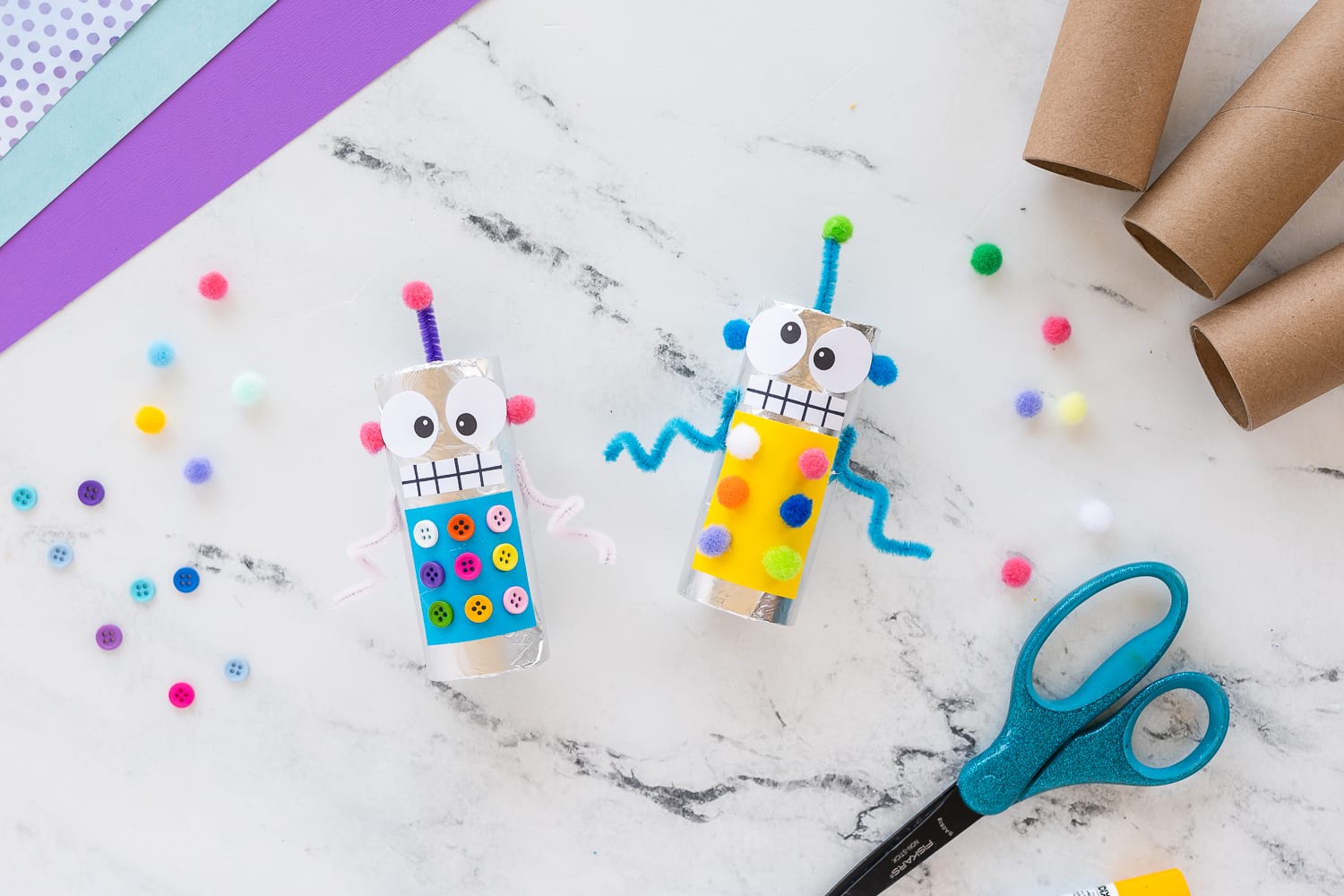 Attaching buttons and pom poms to decorate a robot craft for kids
