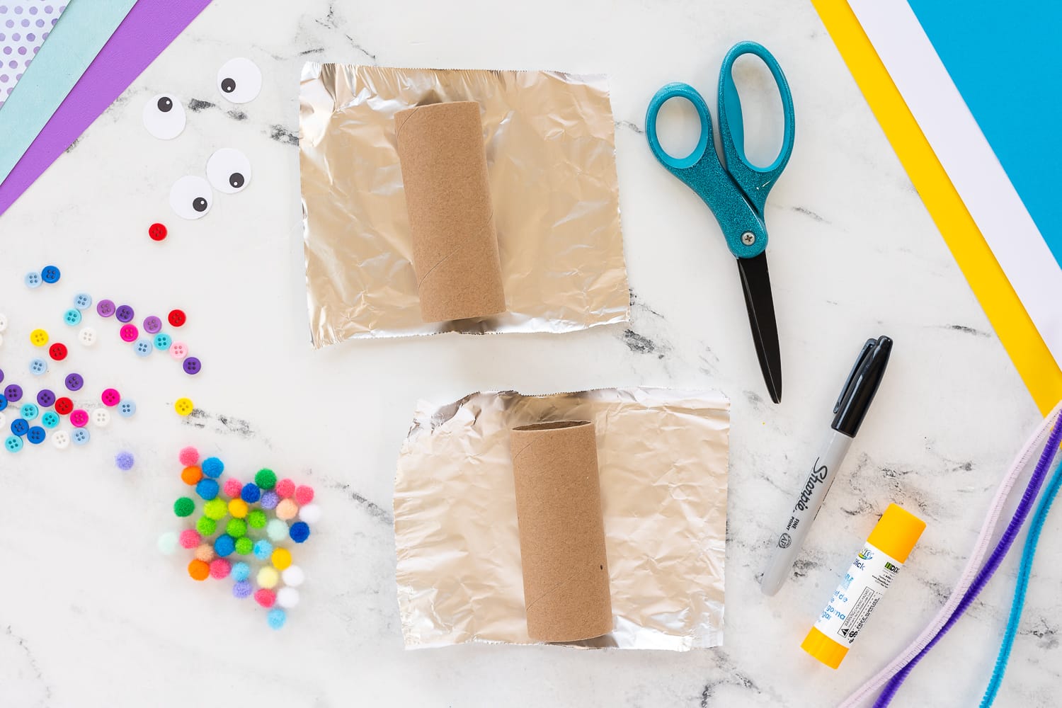 Wrapping a toilet paper roll in aluminum foil for a robot craft