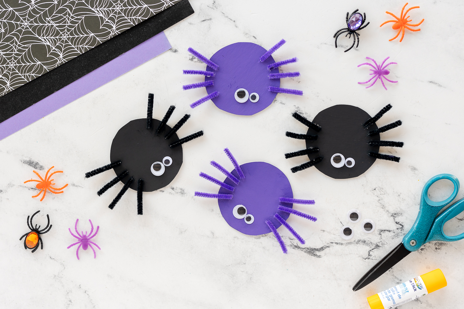 Easy Pipe Cleaner Spiders on counter with faux leaves