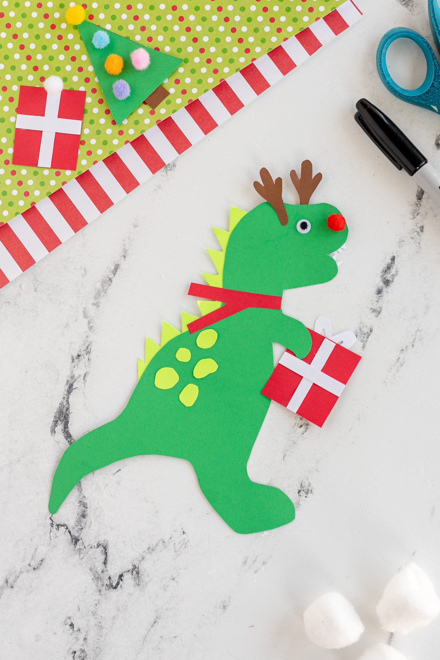 green christmas dinosaur with gift