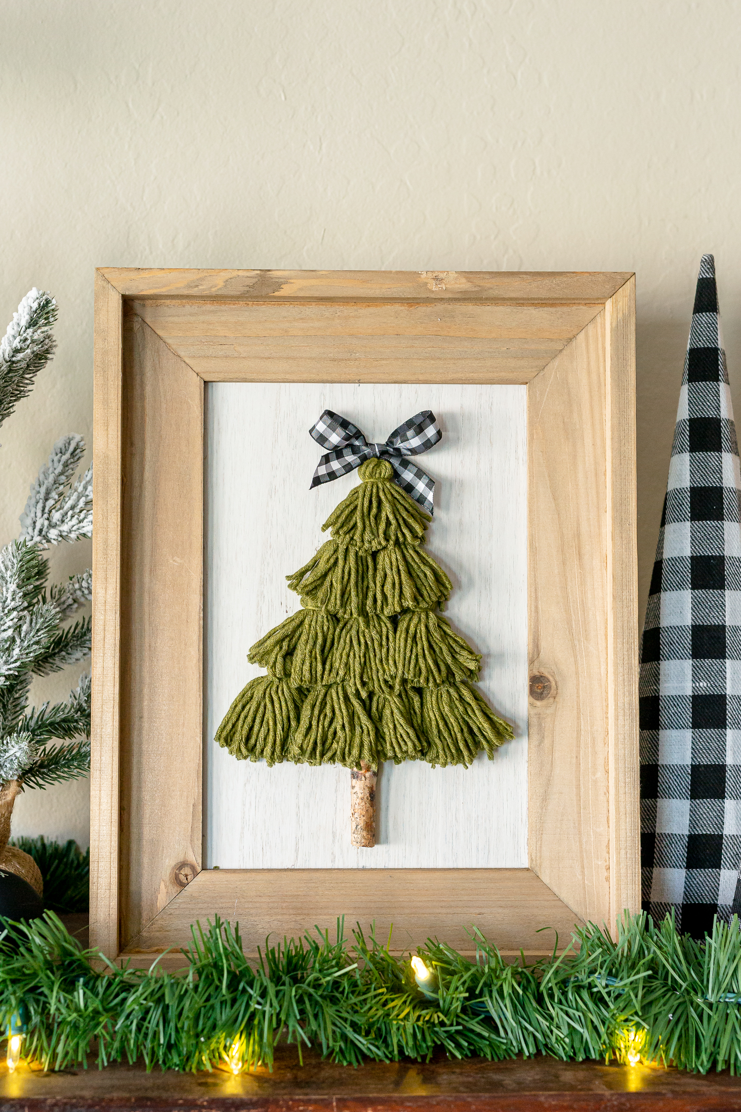Tassel Tree Craft on shelf with greenery lights, and Christmas decor