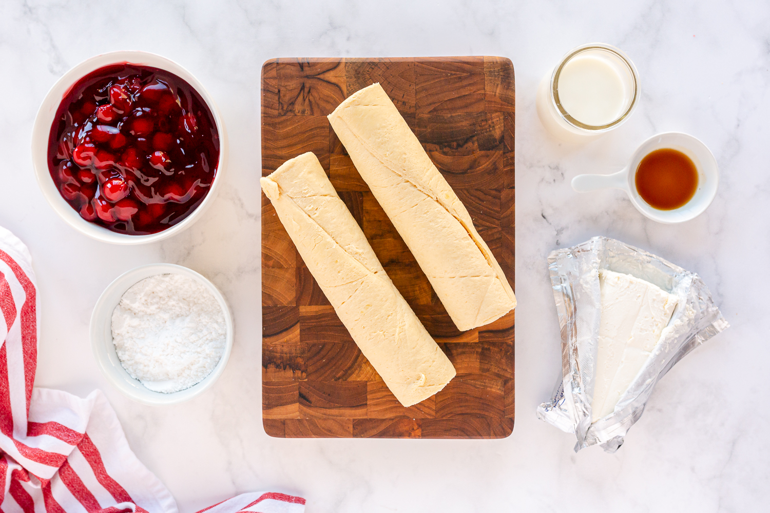 supplies on counter - cherry pie filling, crescent rolls, cream cheese, powdered sugar