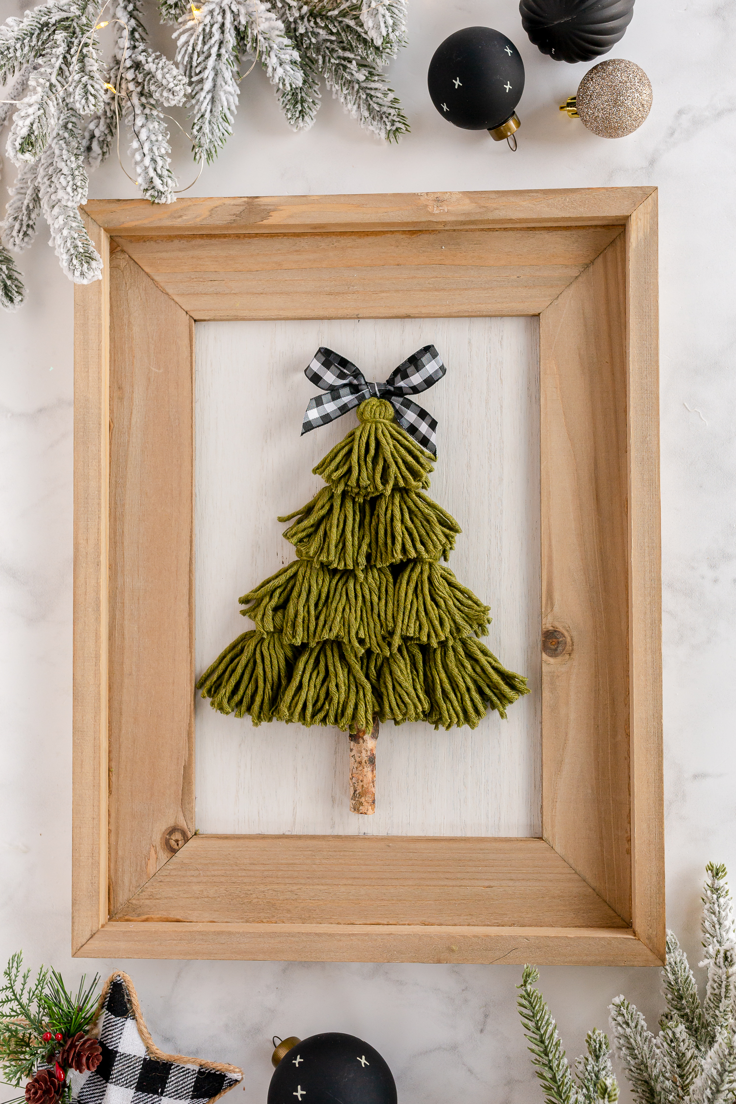 tassel tree on wooden sign on counter with farmhouse ornaments