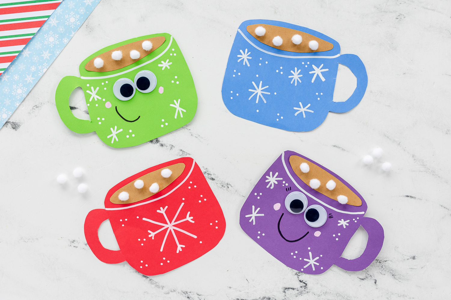 cardstock cut into mug shape with hand drawn white snowflakes