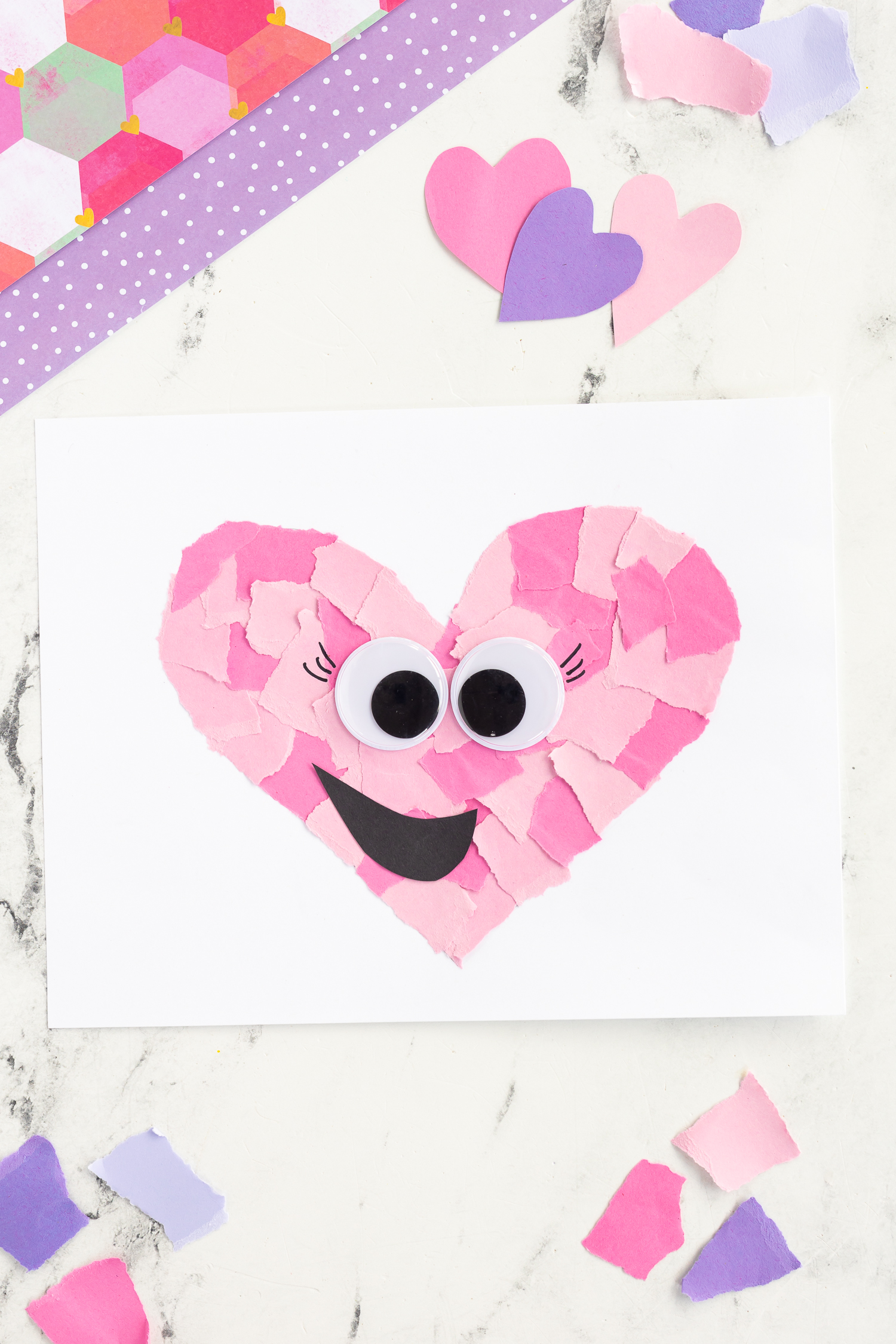 pink cardstock ripped into heart shape