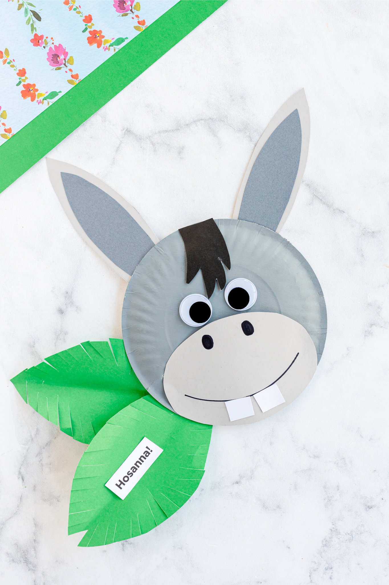 Paper Plate Donkey with green leaves and white tag saying Hosanna!