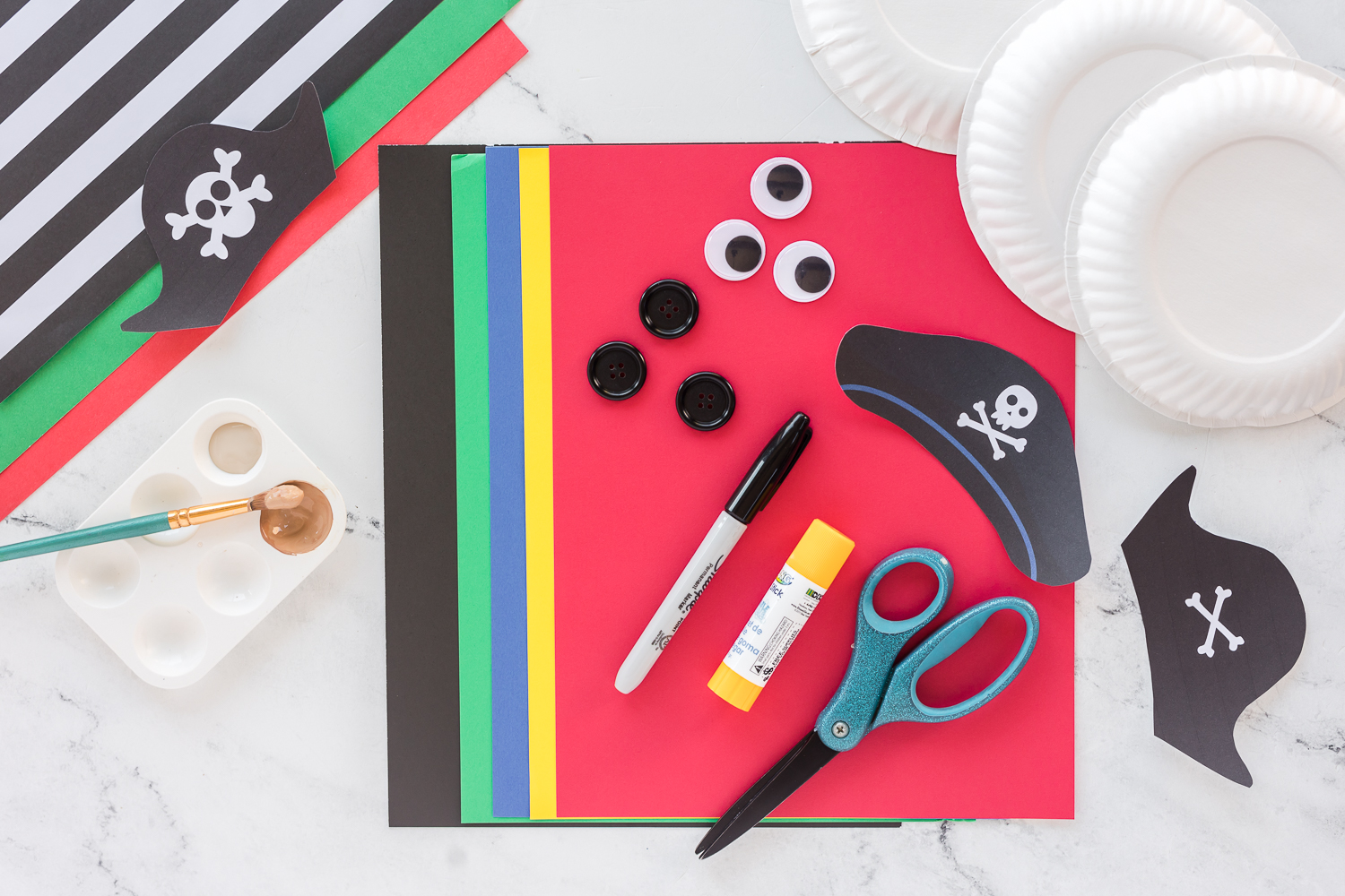 supplies needed to make pirates on counter - paint, marker, colored cardstock, scissors and glue