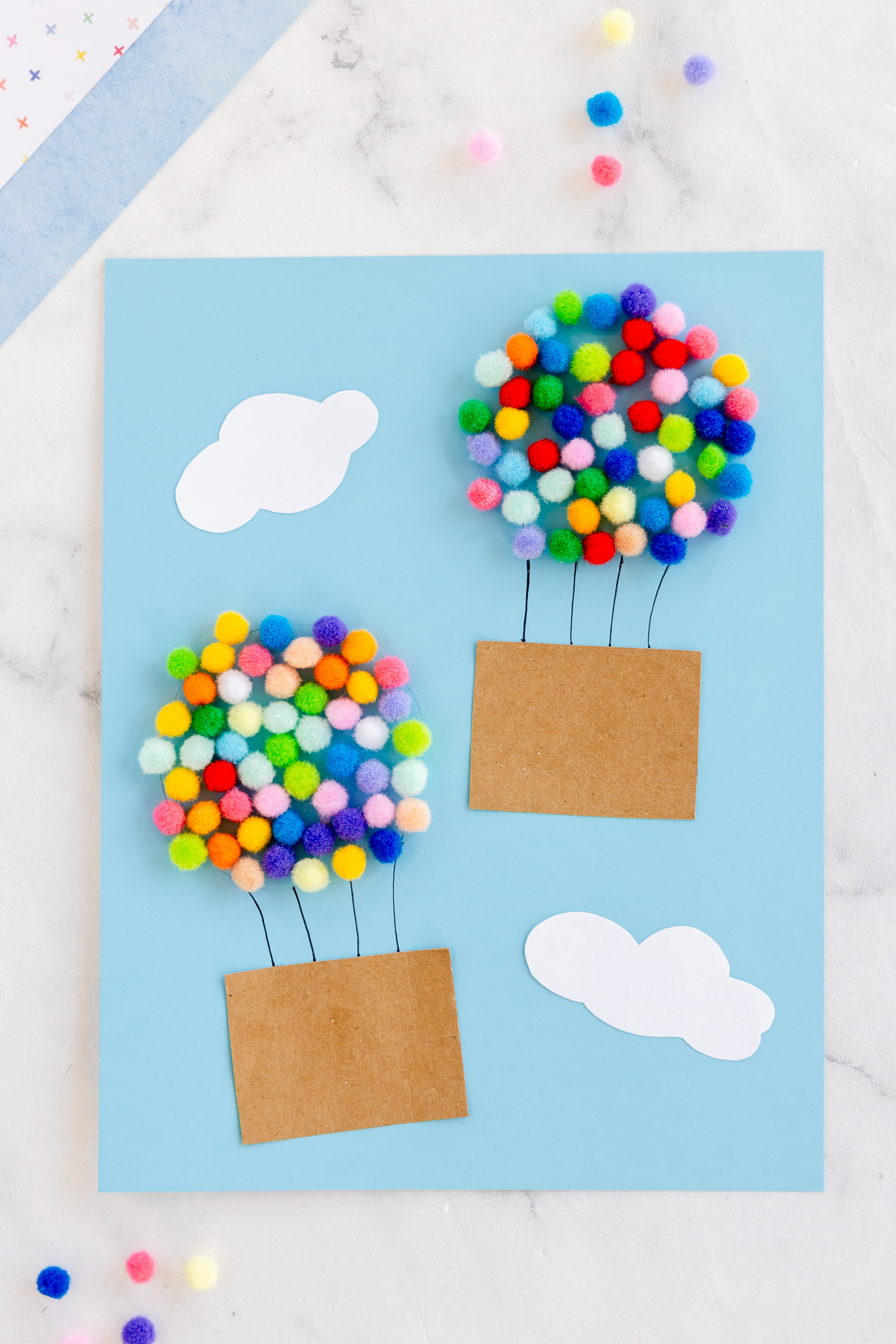paper hot air balloon craft with colorful pom poms