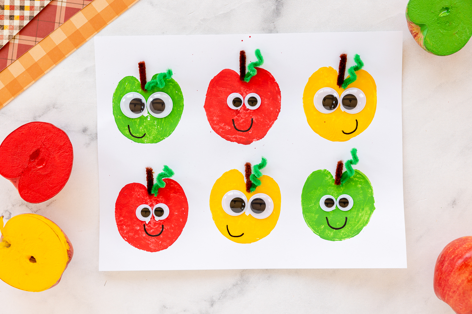 Apple Stamping Craft on counter with painted apples near by