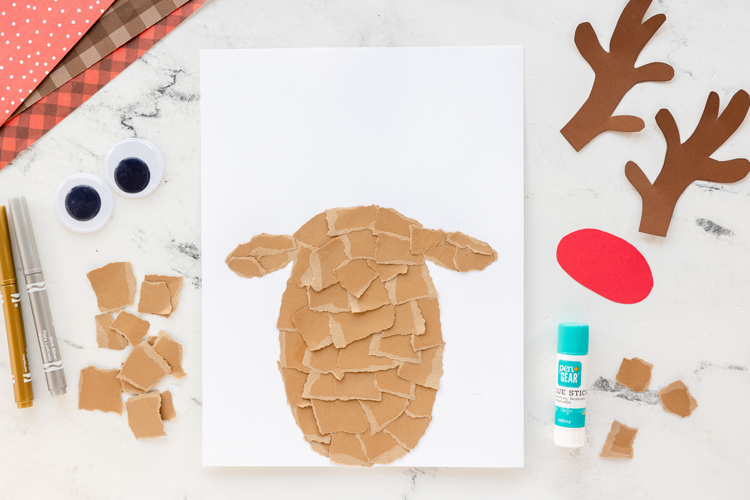 paper ripped and placed on reindeer shape head on cardstock