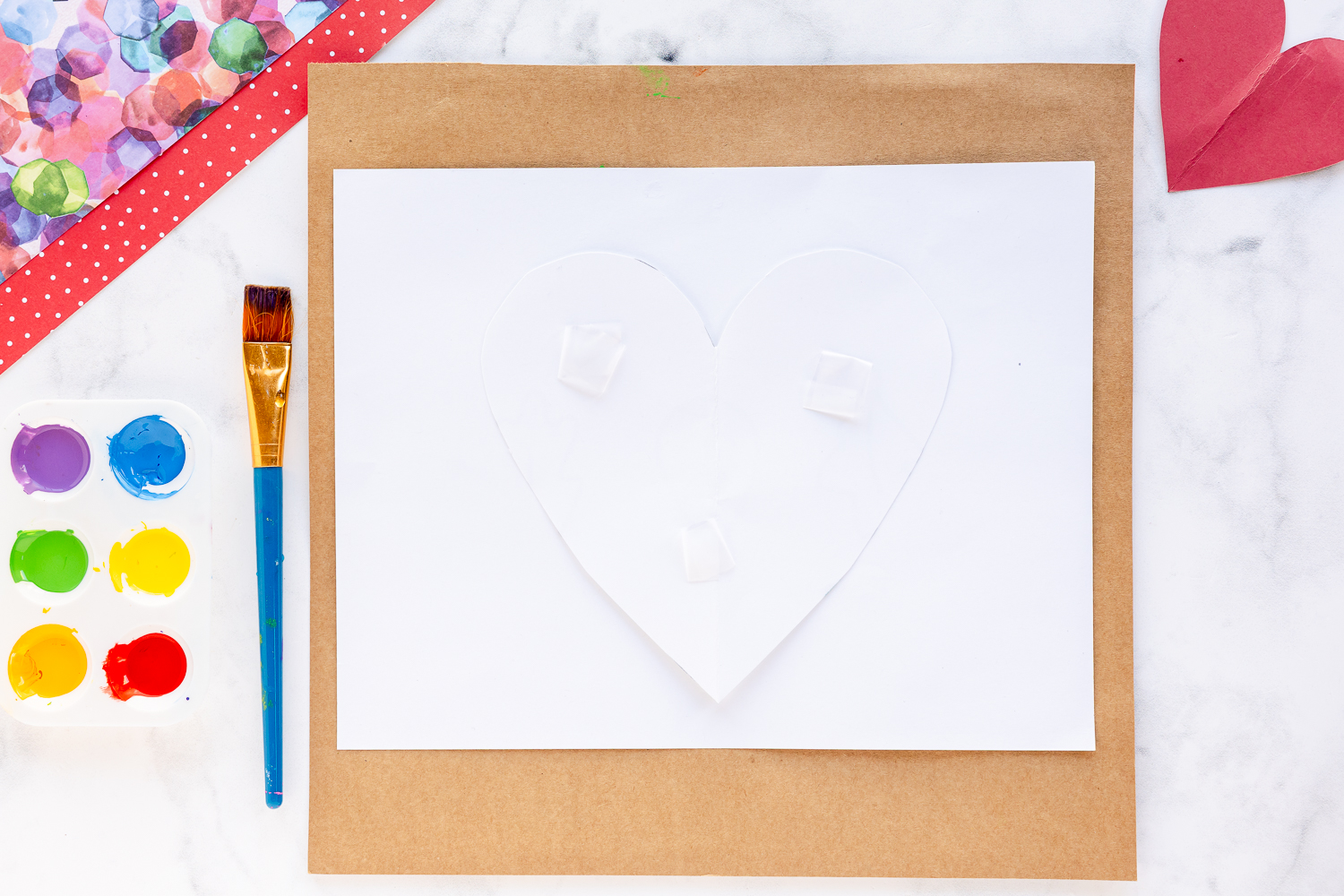 white heart taped to middle of white cardstock paper