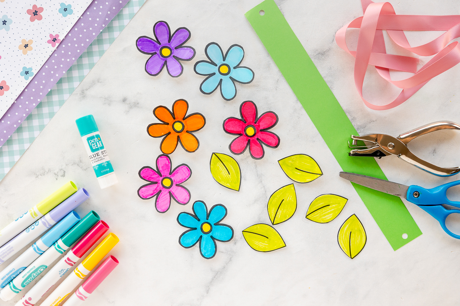 printable flowers colored with markers and supplies nearby