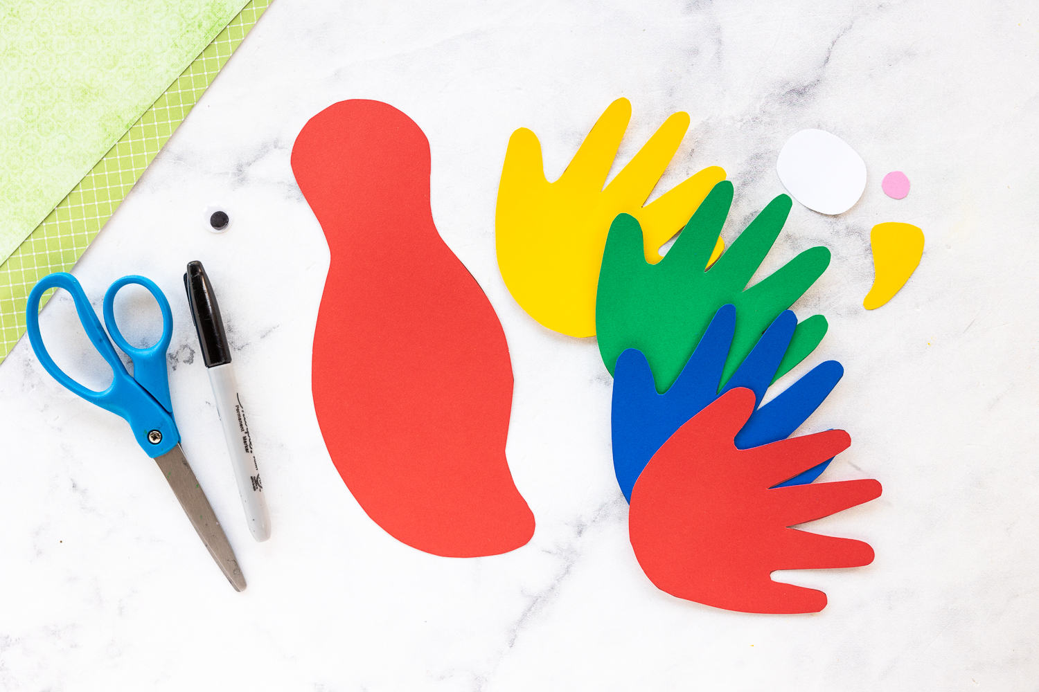 handprints cut from green, yellow, blue and red paper