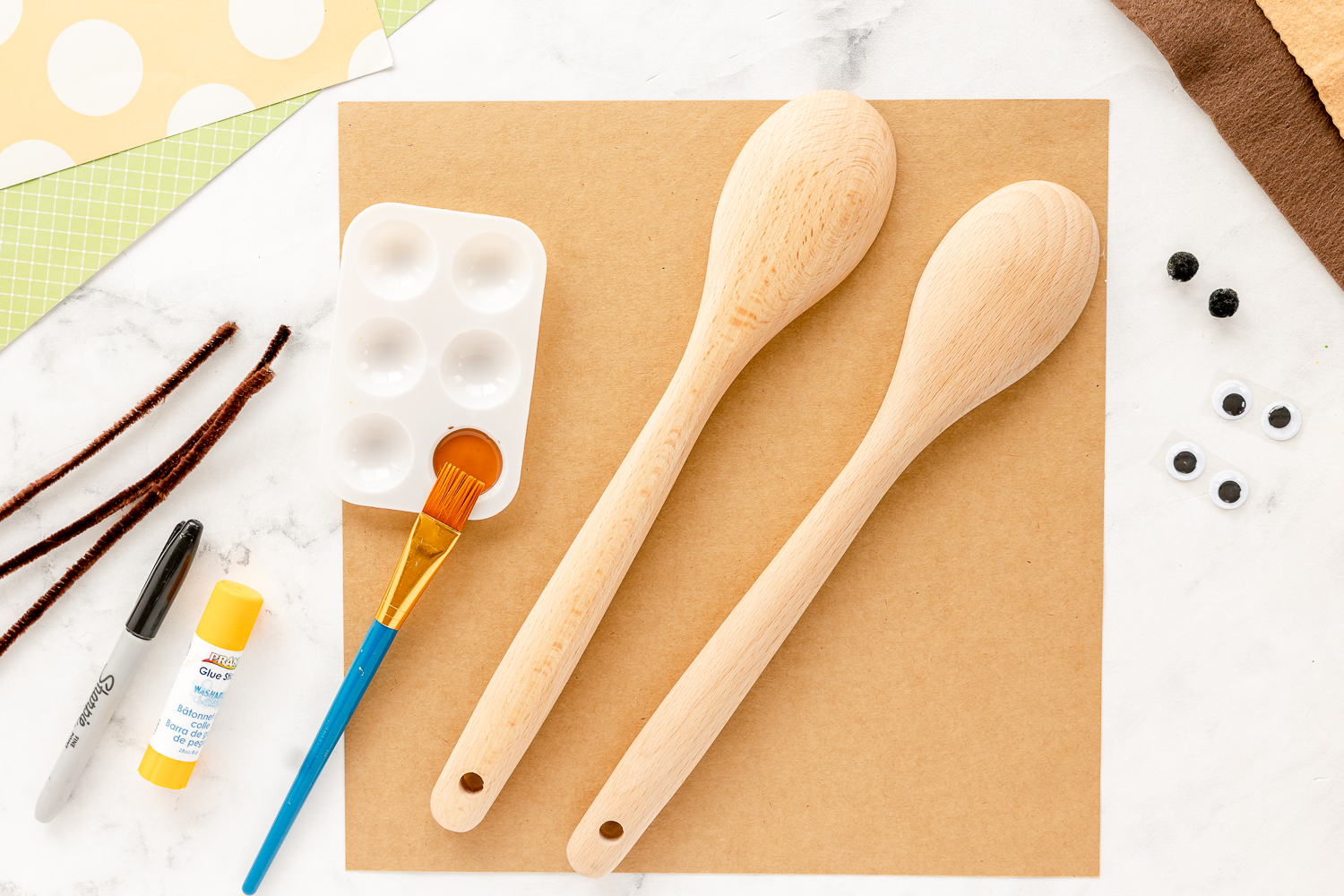 wooden spoons, paint, felt and other supplies on craft counter