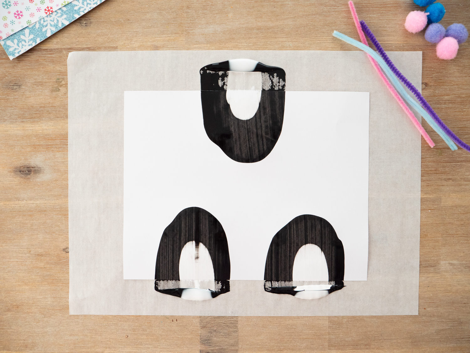 Scraping paint downward to form penguin body