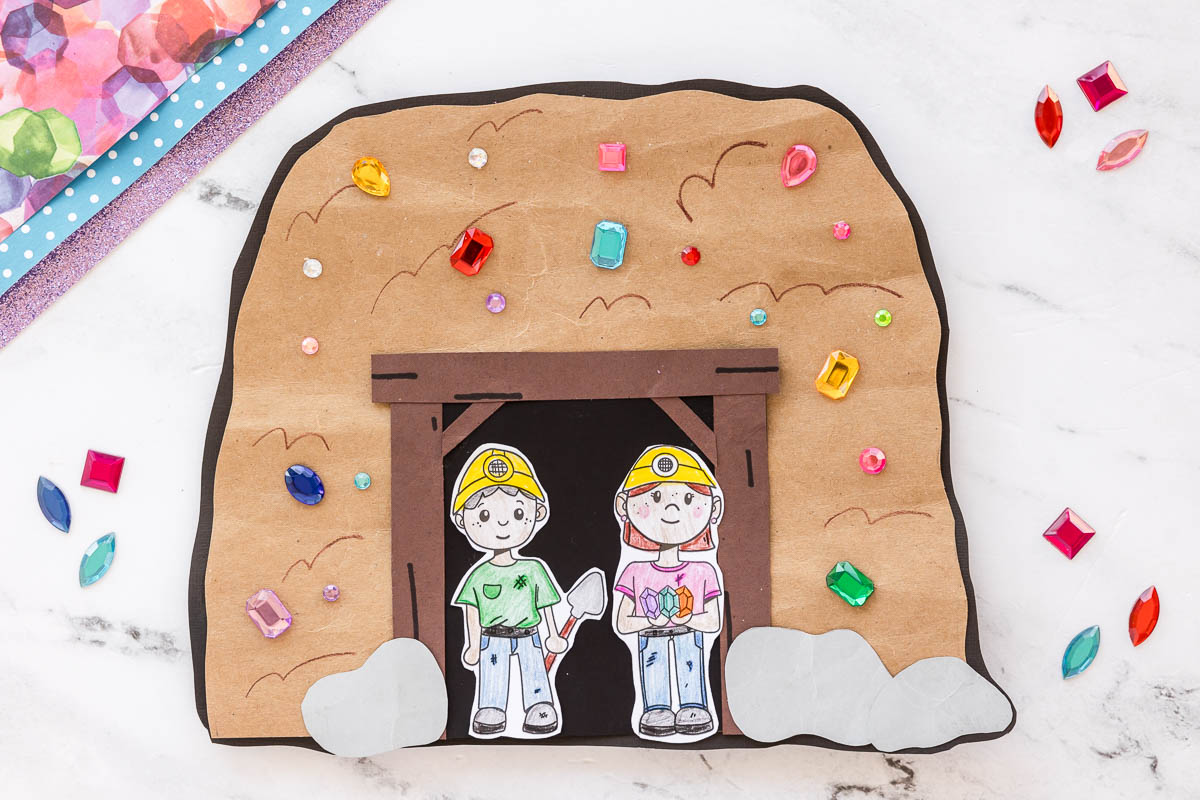Mining craft for kids featuring a cave scene with gem stickers