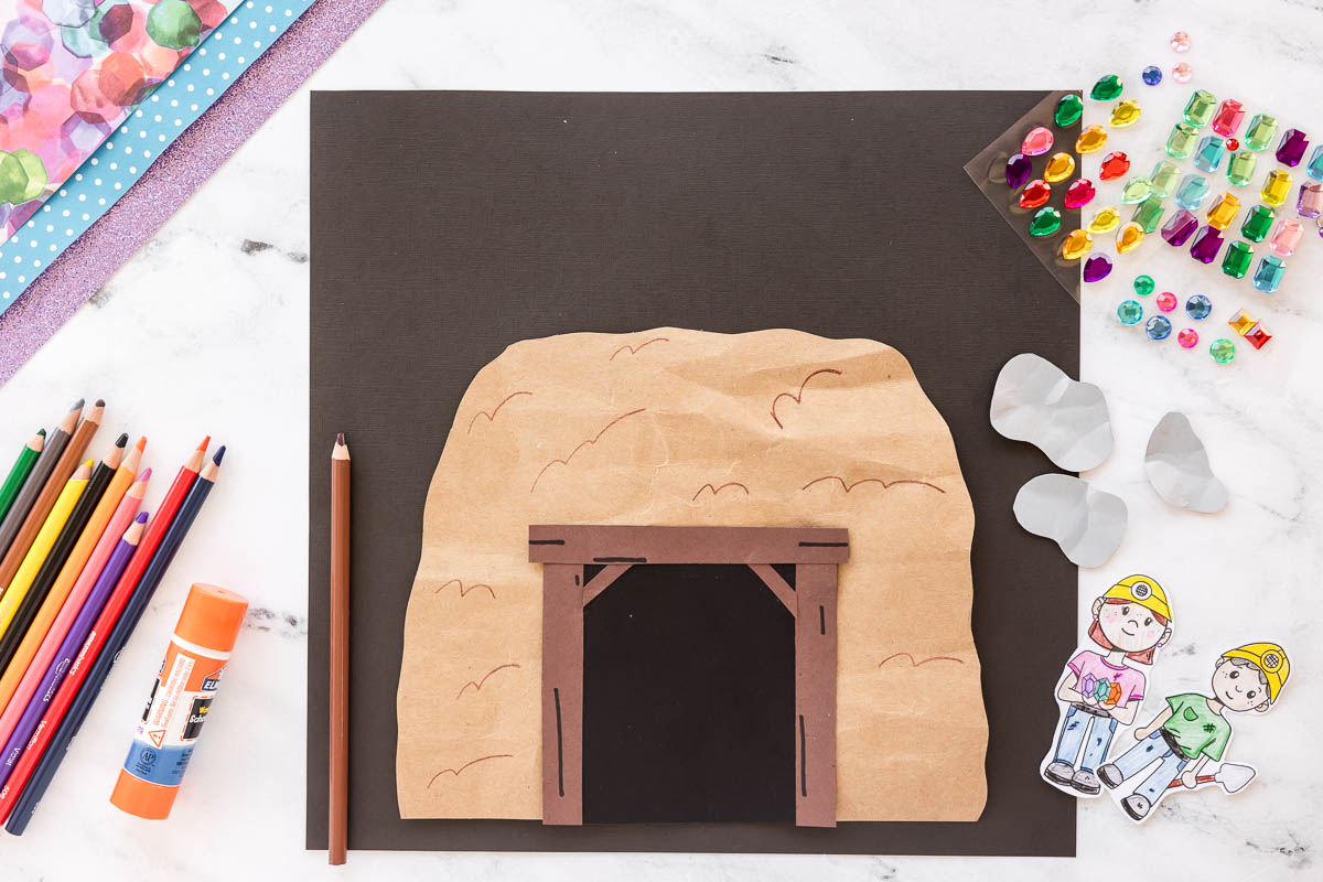 Kids mining craft with cave entrance and paper rocks with additional brown lines drawn on the rock