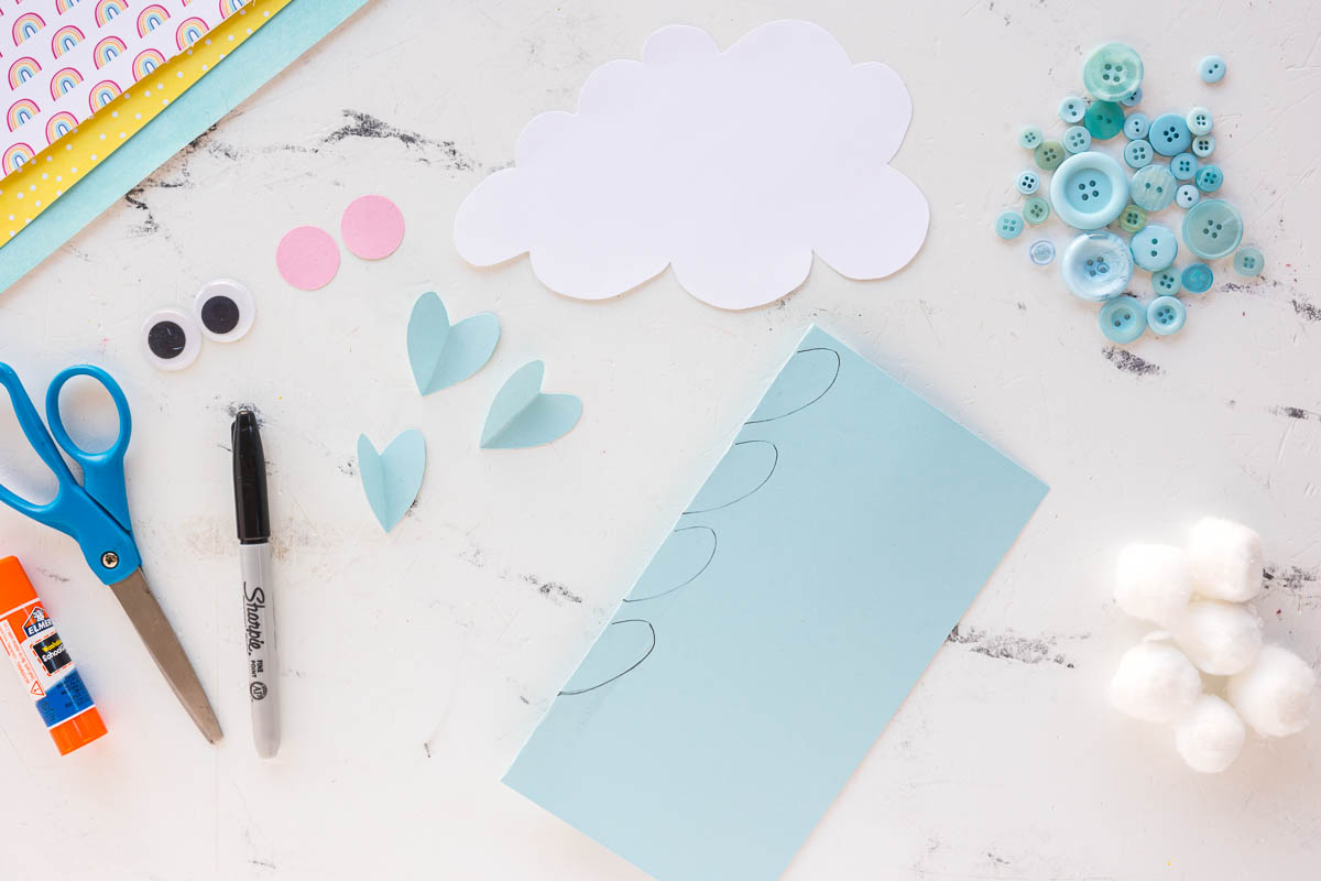 small hearts traced onto a light piece of blue paper 