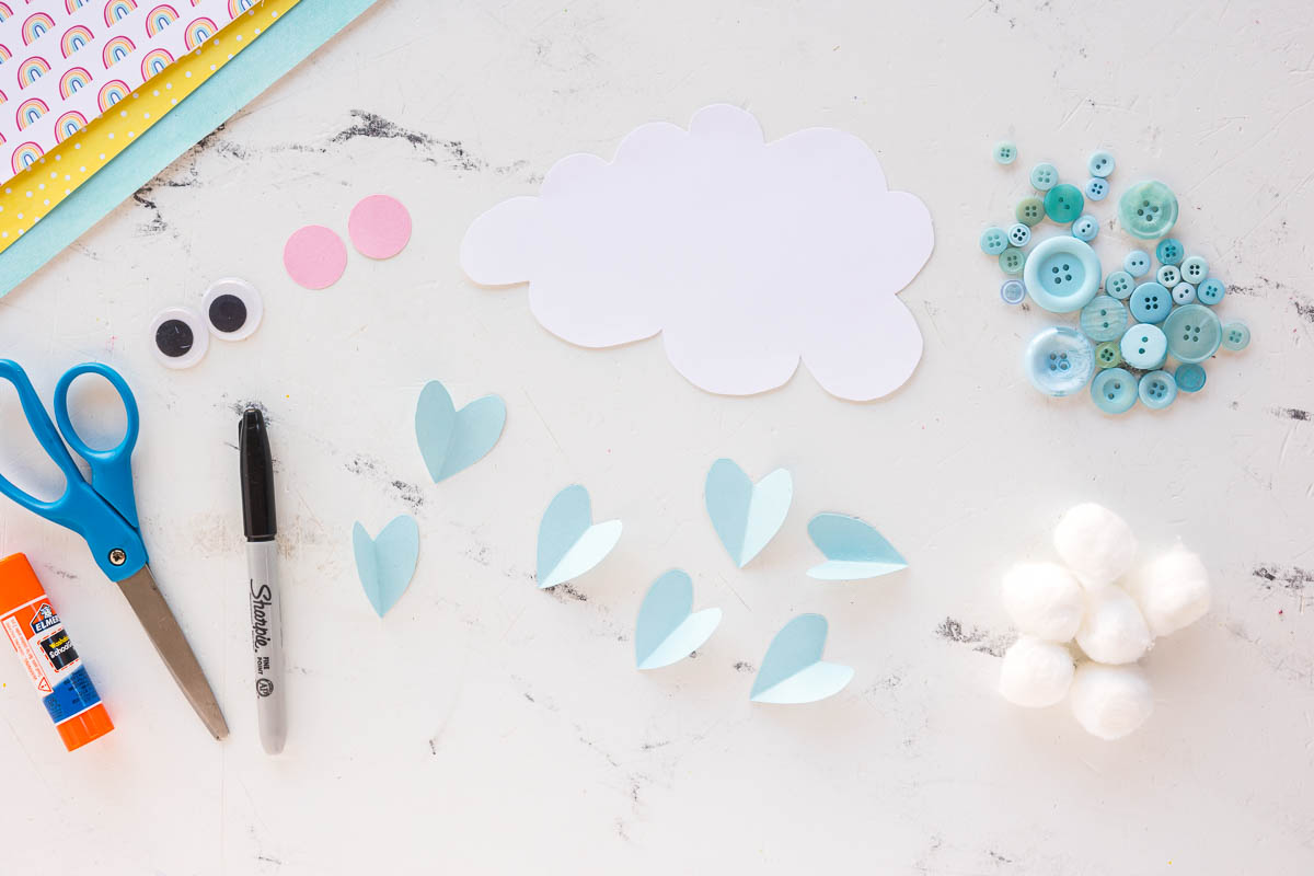 small light blue hearts cut out along with a  white cloud and pink circle for cheeks for the face