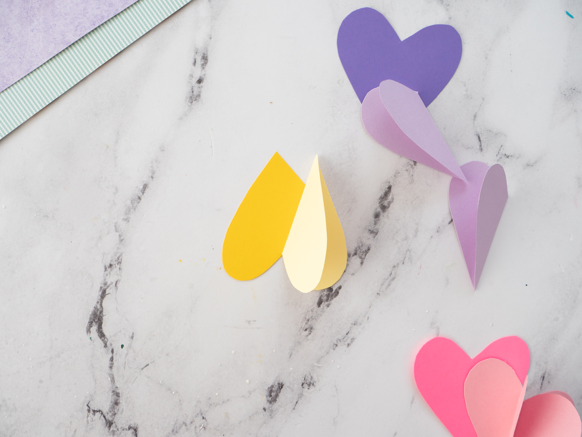 gluing one side of folded heart to base heart