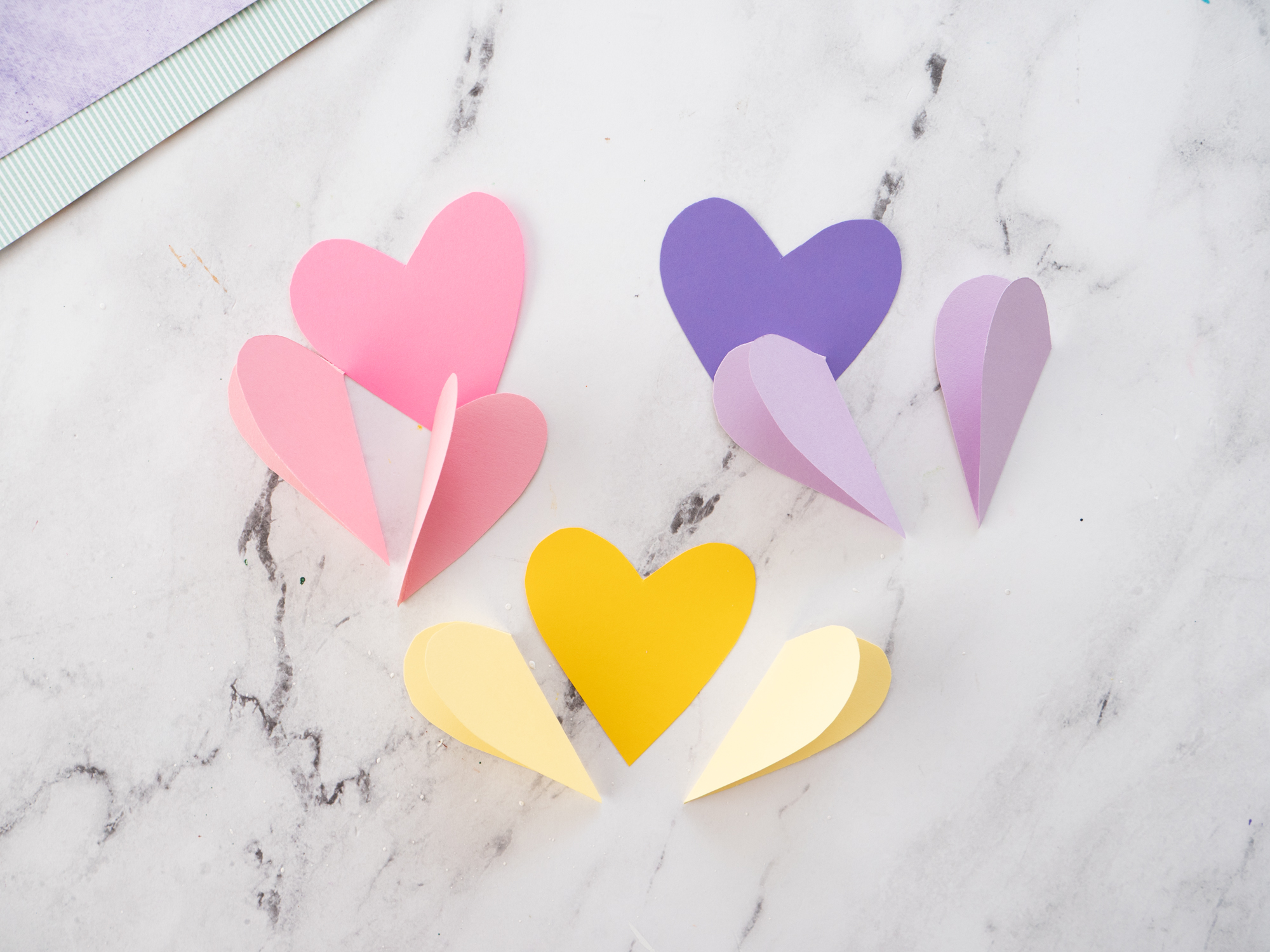 three paper hearts in different shades for tulip petals