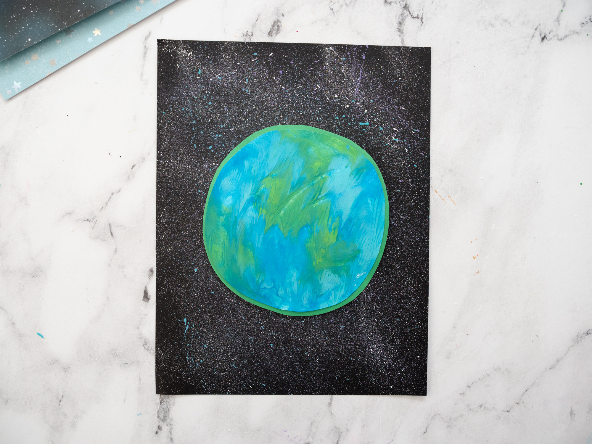 gluing Earth painting onto black paper space background