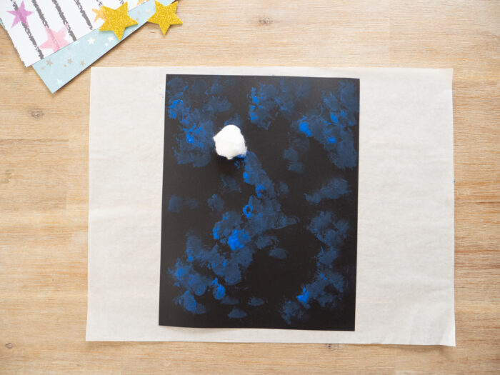 kids painting galaxy background with cotton balls for space craft