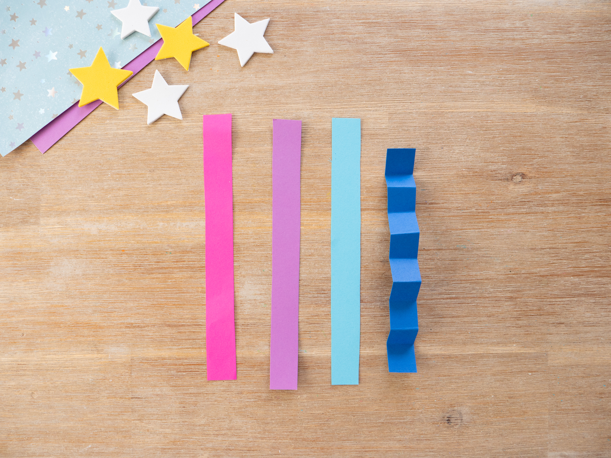 making accordion folds with paper strips for space craft