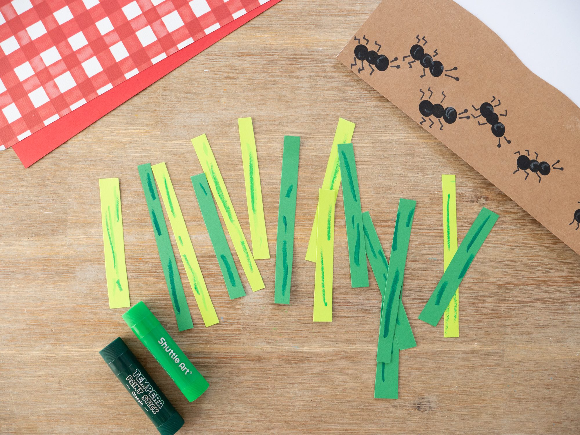 Green paper strips glued above the fingerprint ants to create tall garden grass